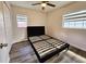 Simple bedroom with a platform bed and two windows at 10007 N 22Nd St, Tampa, FL 33612