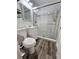 Clean bathroom with a toilet, sink, and walk-in shower at 10007 N 22Nd St, Tampa, FL 33612