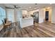 Open concept kitchen with island, white cabinetry, and stainless steel appliances at 10007 N 22Nd St, Tampa, FL 33612