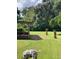 Spacious backyard with covered patio and mature trees at 2705 Ranch Rd, Dover, FL 33527