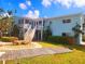 Two-story light blue building with stairs and walkway at 241 Skiff Pt # 4, Clearwater Beach, FL 33767