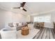 Bright living room with comfy seating, wood-look floors, and coastal decor at 241 Skiff Pt # 4, Clearwater Beach, FL 33767