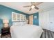 Primary bedroom with king bed, teal walls, and hardwood floors at 241 Skiff Pt # 4, Clearwater Beach, FL 33767