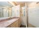 Bathroom with granite countertop, light wood cabinets at 241 Skiff Pt # 4, Clearwater Beach, FL 33767