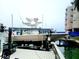 Tan and white center console boat on a lift at 241 Skiff Pt # 4, Clearwater Beach, FL 33767