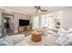 Living room features a large TV, comfy seating, and wood-look floors at 241 Skiff Pt # 4, Clearwater Beach, FL 33767