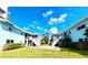 Two-story light blue building with courtyard and stairs at 241 Skiff Pt # 4, Clearwater Beach, FL 33767