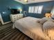 Bedroom with a king-size bed, dresser, and coastal decor at 241 Skiff Pt # 4, Clearwater Beach, FL 33767