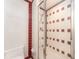 Bathroom with a shower and toilet. Red and white tile accents at 241 Skiff Pt # 4, Clearwater Beach, FL 33767