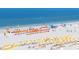 Aerial view of Clearwater Beach with numerous beach umbrellas and chairs at 241 Skiff Pt # 4, Clearwater Beach, FL 33767