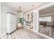 Sunroom features built-in shelving, wood-look floors, and a view at 241 Skiff Pt # 4, Clearwater Beach, FL 33767