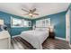 Primary bedroom with a king-size bed and teal walls at 241 Skiff Pt # 4, Clearwater Beach, FL 33767