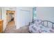 Cozy bedroom with twin bed, window, and built in closet at 656 Spring Lake W Cir, Tarpon Springs, FL 34688