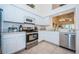 Bright kitchen features stainless steel appliances and white cabinets at 656 Spring Lake W Cir, Tarpon Springs, FL 34688