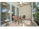 Relaxing screened porch with seating and ceiling fan at 656 Spring Lake W Cir, Tarpon Springs, FL 34688