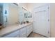 Bright bathroom with single vanity, good storage and linen closet at 656 Spring Lake W Cir, Tarpon Springs, FL 34688