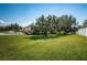 House exterior with a large tree in the front yard at 656 Spring Lake W Cir, Tarpon Springs, FL 34688