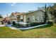 Tan house with two-car garage and manicured lawn at 656 Spring Lake W Cir, Tarpon Springs, FL 34688