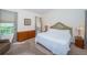 Main bedroom with king-size bed and wood dresser at 656 Spring Lake W Cir, Tarpon Springs, FL 34688