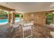 Covered patio area with table and chairs near pool at 656 Spring Lake W Cir, Tarpon Springs, FL 34688