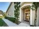 Front entry with a glass door and a welcome mat at 656 Spring Lake W Cir, Tarpon Springs, FL 34688