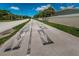 Asphalt road with pedestrian walkway and street markings at 656 Spring Lake W Cir, Tarpon Springs, FL 34688