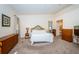 Spacious Primary bedroom with carpeted floors and ensuite bathroom access at 656 Spring Lake W Cir, Tarpon Springs, FL 34688