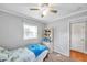 Simple bedroom with ceiling fan, window and twin bed at 4317 S Hale Ave, Tampa, FL 33611