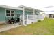 Inviting home featuring a covered carport with golf cart, a cozy porch with white picket fence, and manicured lawn at 107 W Saint Johns Way, Apollo Beach, FL 33572