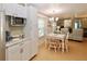 Bright kitchen with white cabinets, stainless steel appliances and breakfast nook at 107 W Saint Johns Way, Apollo Beach, FL 33572