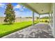 The backyard has a covered patio, brick pavers, a green lawn, and a privacy fence at 13720 Brookside Haven St, Riverview, FL 33578