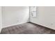 Cozy bedroom with plush gray carpet, white walls and natural light from the window at 13720 Brookside Haven St, Riverview, FL 33578