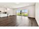 An empty room with wood floors and sliding glass doors leading to the backyard at 13720 Brookside Haven St, Riverview, FL 33578