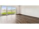 Empty room with wood floors and sliding glass doors to the outdoor area at 13720 Brookside Haven St, Riverview, FL 33578