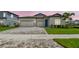 Charming single-Gathering home with a paved driveway, well-manicured lawn, and a three-car garage at 13720 Brookside Haven St, Riverview, FL 33578