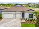 Charming single-story home featuring a paver driveway and a two-car garage at 13720 Brookside Haven St, Riverview, FL 33578