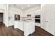 A stylish kitchen boasts white cabinets, stainless steel appliances, and an island at 13720 Brookside Haven St, Riverview, FL 33578