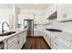 Modern kitchen featuring white cabinets, stainless appliances, and a tile backsplash at 13720 Brookside Haven St, Riverview, FL 33578
