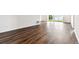 Spacious living area featuring hardwood flooring, white walls, and natural light at 13720 Brookside Haven St, Riverview, FL 33578