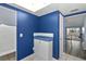 White kitchen cabinets and blue walls, with a built-in counter and storage at 1868 Shore S Dr # 207, South Pasadena, FL 33707