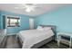Bedroom with light gray bed frame, white bedding, and ceiling fan at 1868 Shore S Dr # 207, South Pasadena, FL 33707