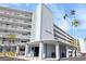 Condo building exterior, showing the entrance and landscaping at 1868 Shore S Dr # 207, South Pasadena, FL 33707