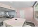Bright dining area with white table and seating for four, overlooking living room at 1868 Shore S Dr # 207, South Pasadena, FL 33707