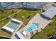 Community pool and shuffleboard area with covered seating at 1868 Shore S Dr # 207, South Pasadena, FL 33707