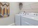 Laundry room with side-by-side washer and dryer, and shelving at 3092 Living Coral St, Wimauma, FL 33598