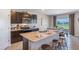 Open kitchen with island, stainless steel appliances, and view to backyard at 3092 Living Coral St, Wimauma, FL 33598