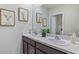 Bathroom with double sinks, granite countertop, and a shower at 3092 Living Coral St, Wimauma, FL 33598