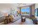 Bright sitting room with large window, comfy couch, and TV at 3092 Living Coral St, Wimauma, FL 33598
