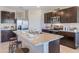 Modern kitchen with granite countertops, stainless steel appliances, and an island at 3092 Living Coral St, Wimauma, FL 33598