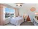 Bright bedroom with a full bed and geometric wall accents at 3092 Living Coral St, Wimauma, FL 33598